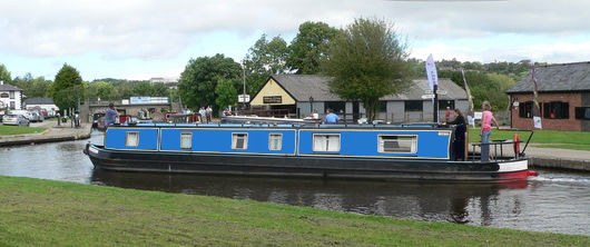 One of our 55 foot, 6 berth canal boats entering the village of Trevor.