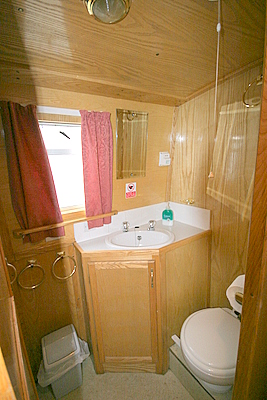 The bathroom which includes flush loo, bath, shower and sink.