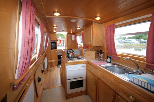 The canal boat is all wood panelled throughout and comfortably furnished.